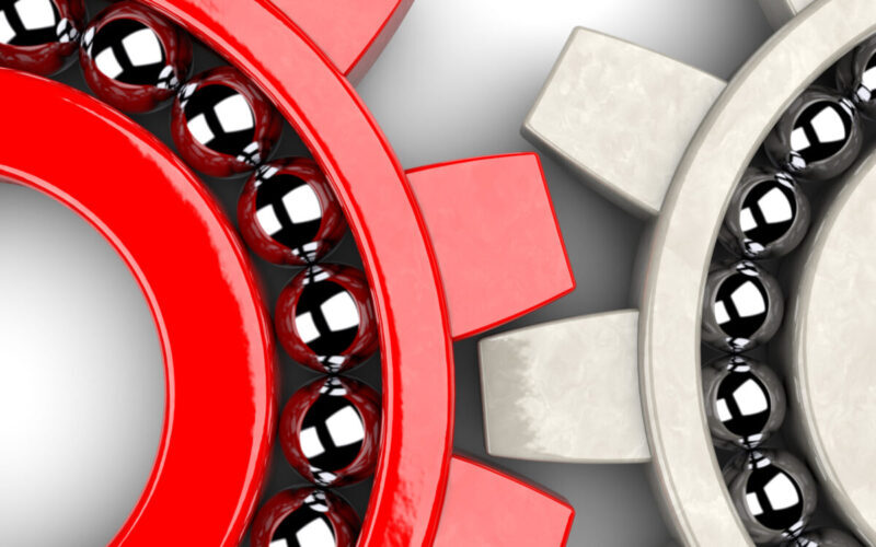 Closeup of two gear bearings illustrating team work as concept